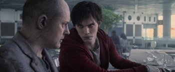 Movie still from “Warm Bodies” (2013), directed by Jonathan Levine – A man in a red jacket is talking to another man in a red jacket; Close Up shot, Over the shoulder angle