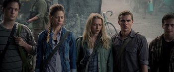 Movie still from “Warm Bodies” (2013), directed by Jonathan Levine – A group of people standing next to each other in front of rocks; Medium shot, Low angle