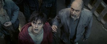 Movie still from “Warm Bodies” (2013), directed by Jonathan Levine – A man and a woman dressed as zombies; Medium shot, Over the shoulder angle