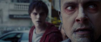 Movie still from “Warm Bodies” (2013), directed by Jonathan Levine – Two men are looking into the camera while one of them is wearing a red jacket; Close Up shot, Over the shoulder angle
