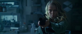 Movie still from “Warm Bodies” (2013), directed by Jonathan Levine – A woman is holding a gun in a room; Close Up shot, Low angle