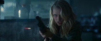 Movie still from “Warm Bodies” (2013), directed by Jonathan Levine – A woman holding a gun in a dark room; Close Up shot, Over the shoulder angle