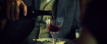 Movie still from “Warm Bodies” (2013), directed by Jonathan Levine – A glass of red wine being poured into a wine goblet; Extreme Close Up shot, High angle