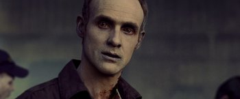 Movie still from “Warm Bodies” (2013), directed by Jonathan Levine – A person wearing a shirt with blood all over his face; Close Up shot, Over the shoulder angle