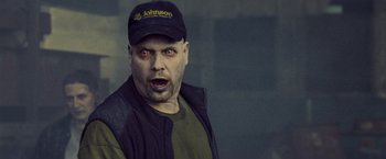 Movie still from “Warm Bodies” (2013), directed by Jonathan Levine – A man wearing a baseball cap and a jacket; Close Up shot, Over the shoulder angle