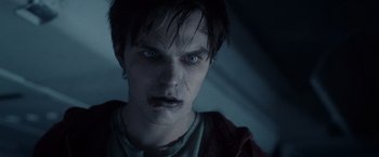 Movie still from “Warm Bodies” (2013), directed by Jonathan Levine – A person with a vampire look on his face; Close Up shot, Low angle