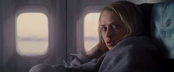Movie still from “Warm Bodies” (2013), directed by Jonathan Levine – A woman sitting on a plane with her hand on her face; Close Up shot, Low angle