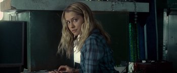 Movie still from “Warm Bodies” (2013), directed by Jonathan Levine – A woman sitting in front of a laptop computer; Medium shot, Over the shoulder angle