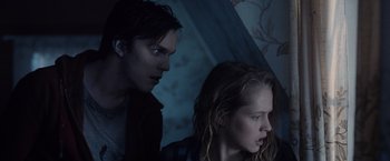 Movie still from “Warm Bodies” (2013), directed by Jonathan Levine – A man and a woman sitting next to each other in a dark room; Close Up shot, Low angle