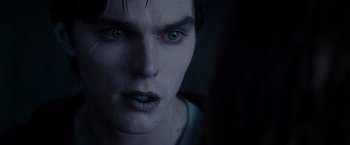 Movie still from “Warm Bodies” (2013), directed by Jonathan Levine – A man's blue eyes in a dark room; Close Up shot, Over the shoulder angle