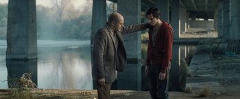 Movie still from “Warm Bodies” (2013), directed by Jonathan Levine – Two men standing next to each other near a body of water; Medium shot, Over the shoulder angle