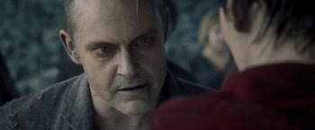 Movie still from “Warm Bodies” (2013), directed by Jonathan Levine – An older man with gray hair stares into the camera; Close Up shot, Over the shoulder angle