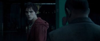 Movie still from “Warm Bodies” (2013), directed by Jonathan Levine – A young man in a red jacket standing next to a wall; Close Up shot, Over the shoulder angle