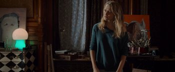 Movie still from “Warm Bodies” (2013), directed by Jonathan Levine – A woman standing in front of a mirror in front of a window; Medium shot, Over the shoulder angle