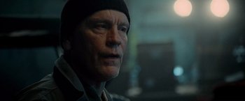 Movie still from “Warm Bodies” (2013), directed by Jonathan Levine – An older man wearing a black hat looking at the camera; Close Up shot, Low angle
