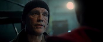 Movie still from “Warm Bodies” (2013), directed by Jonathan Levine – An older man wearing a hat looking at the camera; Close Up shot, Over the shoulder angle