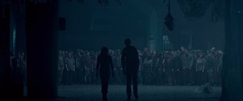 Movie still from “Warm Bodies” (2013), directed by Jonathan Levine – A couple of people standing next to each other in front of a group of people; Wide shot, Low angle