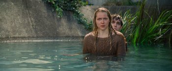 Movie still from “Warm Bodies” (2013), directed by Jonathan Levine – A woman and a man standing in a body of water; Medium shot, Over the shoulder angle