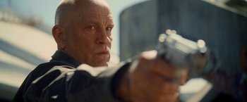 Movie still from “Warm Bodies” (2013), directed by Jonathan Levine – An older man is holding a gun in his hand; Close Up shot, Low angle