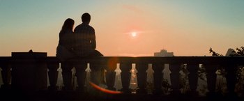 Movie still from “Warm Bodies” (2013), directed by Jonathan Levine – Two people sitting on a bench watching the sun go down; Wide shot, Low angle