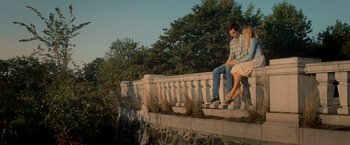 Movie still from “Warm Bodies” (2013), directed by Jonathan Levine – A man and a woman sitting on a ledge; Wide shot, High angle