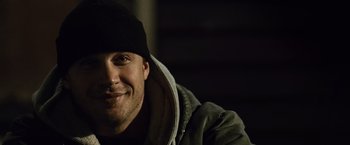Movie still from “Warrior” (2011), directed by Gavin O'Connor – A person wearing a jacket and a hat; Close Up shot, Low angle