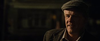Movie still from “Warrior” (2011), directed by Gavin O'Connor – An older man wearing a hat and a jacket; Close Up shot, Over the shoulder angle