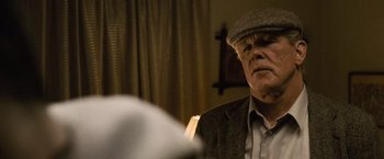 Movie still from “Warrior” (2011), directed by Gavin O'Connor – An older man wearing a hat and a jacket; Close Up shot, Low angle