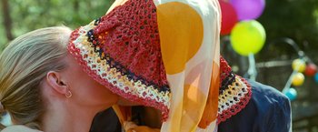 Movie still from “Warrior” (2011), directed by Gavin O'Connor – View of a woman wearing an orange and yellow scarf; Extreme Close Up shot, Over the shoulder angle