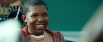 Movie still from “Warrior” (2011), directed by Gavin O'Connor – A person with a smile on their face; Close Up shot, Low angle