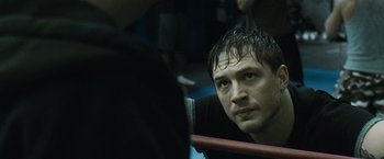 Movie still from “Warrior” (2011), directed by Gavin O'Connor – A person sitting on a bus; Close Up shot, Over the shoulder angle