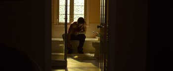 Movie still from “Warrior” (2011), directed by Gavin O'Connor – A man sitting in a bath tub next to a toilet; Wide shot, Low angle