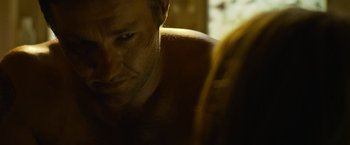 Movie still from “Warrior” (2011), directed by Gavin O'Connor – A man's face in a dark room; Close Up shot, Over the shoulder angle