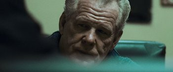 Movie still from “Warrior” (2011), directed by Gavin O'Connor – An older man looking down at the ground; Close Up shot, Over the shoulder angle