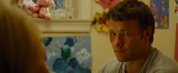 Movie still from “Warrior” (2011), directed by Gavin O'Connor – A person in a room near a window; Close Up shot, Over the shoulder angle