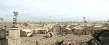 Movie still from “Warrior” (2011), directed by Gavin O'Connor – Many tents are pitched in a field with a sky in the background; Extreme Wide shot, High angle