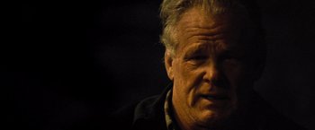 Movie still from “Warrior” (2011), directed by Gavin O'Connor – An older man is looking at the camera; Close Up shot, Over the shoulder angle