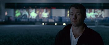 Movie still from “Warrior” (2011), directed by Gavin O'Connor – A man standing in front of a screen; Close Up shot, Over the shoulder angle