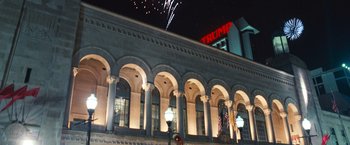Movie still from “Warrior” (2011), directed by Gavin O'Connor – A building that has fireworks in front of it; Extreme Wide shot, Low angle