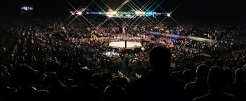 Movie still from “Warrior” (2011), directed by Gavin O'Connor – A crowd of people in a stadium at night; Extreme Wide shot, High angle