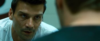 Movie still from “Warrior” (2011), directed by Gavin O'Connor – A man looking at another man in a mirror; Close Up shot, Over the shoulder angle