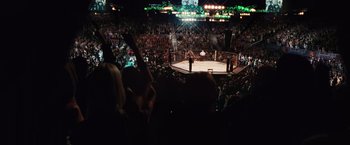 Movie still from “Warrior” (2011), directed by Gavin O'Connor – A crowd of people watching a boxing match; Extreme Wide shot, High angle