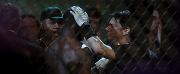 Movie still from “Warrior” (2011), directed by Gavin O'Connor – A group of people in a boxing ring; Close Up shot, Over the shoulder angle