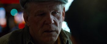 Movie still from “Warrior” (2011), directed by Gavin O'Connor – An older man with a hat on looking into the distance; Close Up shot, Over the shoulder angle