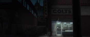 Movie still from “Warrior” (2011), directed by Gavin O'Connor – A building that is lit up at night time; Extreme Wide shot, High angle