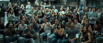 Movie still from “Warrior” (2011), directed by Gavin O'Connor – A large group of men and women sitting in a room; Wide shot, High angle