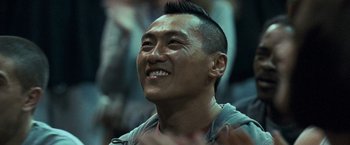 Movie still from “Warrior” (2011), directed by Gavin O'Connor – A person with a shaved head; Close Up shot, Over the shoulder angle