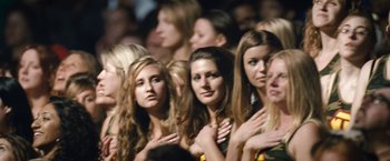 Movie still from “Warrior” (2011), directed by Gavin O'Connor – A group of women standing next to each other in front of a crowd of onlookers; Close Up shot, Low angle