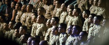 Movie still from “Warrior” (2011), directed by Gavin O'Connor – A group of men in military uniforms standing in front of a crowd; Wide shot, High angle