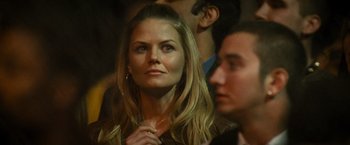 Movie still from “Warrior” (2011), directed by Gavin O'Connor – A beautiful woman with long blonde hair looking at the camera; Close Up shot, Over the shoulder angle